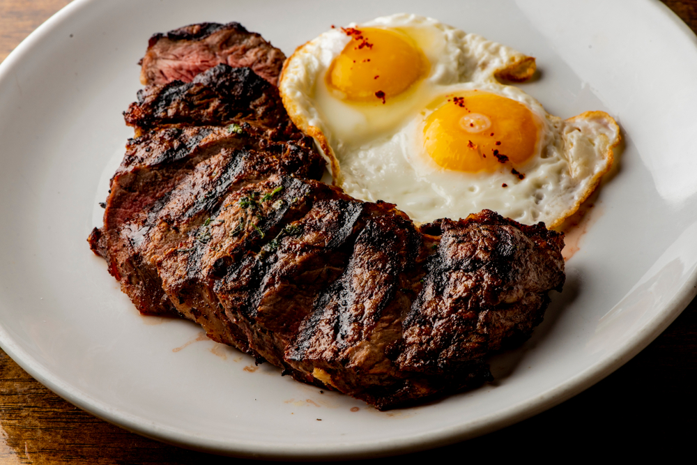 Steak,And,Eggs.,Steak,,Served,Medium,Rare,With,Eggs,Scrambled