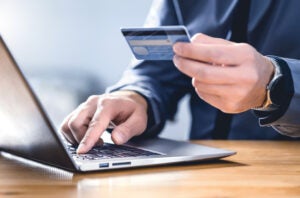 Person paying bill on a laptop