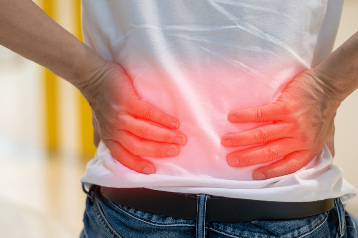 Back Injury -Man's hands on his back with red spot as suffering on backache. Male person sick from lower back pain from Herniated or slipped discs,Degenerative, sacroiliac joint, spinal stenosis, Pancreatic Cancer