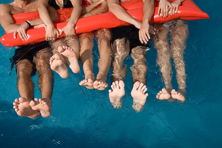 Friends floating in swimming pool
