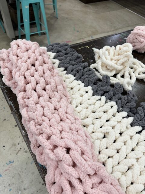 Knit blanket on table - AR Workshop Evans closing