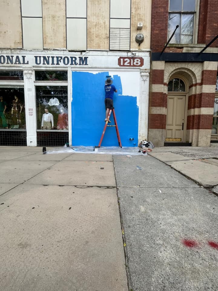 Blue being painted on the wall