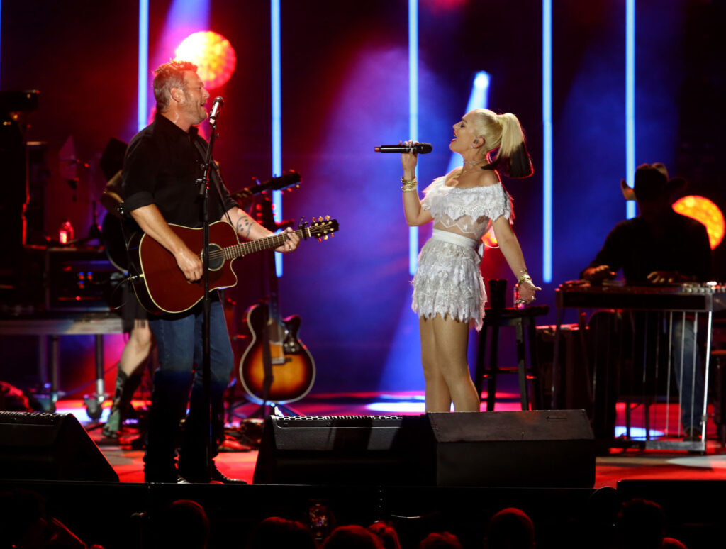 Blake Shelton Wrapped 'One Hell Of A Tour' - Blake on stage with wife Gwen Stefani, who is wearing a white dress. 